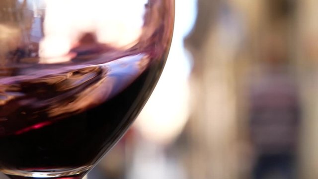 a glass of red wine on the street