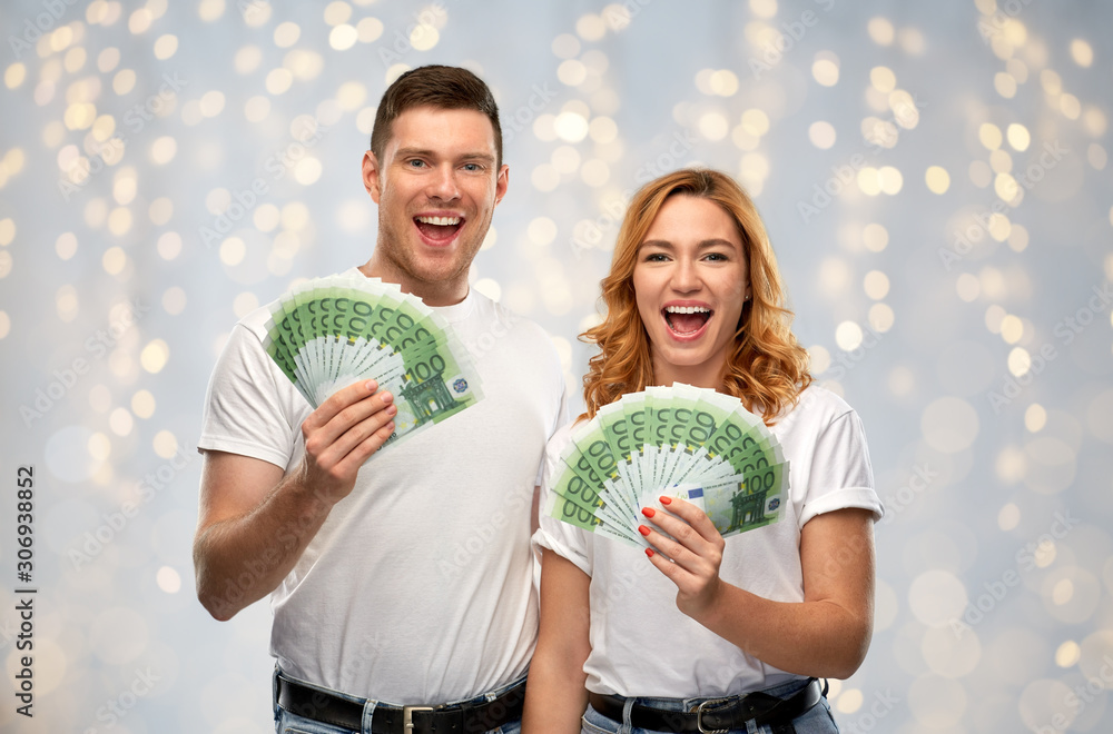 Wall mural finance, saving and people concept - portrait of happy couple in white t-shirts with euro money over