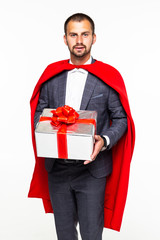 Surprise businessman dressed like superhero holding gifts isolated on white background