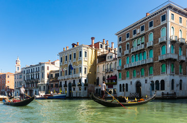 Fototapeta na wymiar Ancient buildings and boats in the Grand canal in Venice. Italy