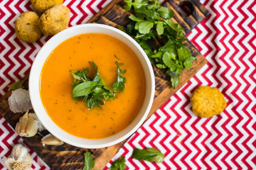 Orange hot pumpkin lentil soup in bowl. Spicy creamy soup with pumpkin puree.