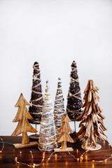 Wooden christmas trees at table.