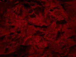 Dark red rock texture. Stone background. Abstract red grunge background. Toned mountain texture.