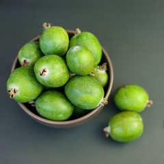 Feijoa green on black background. Feijoa Sellova is a fruit crop from tropical regions. Organic agricultural fruit, healthy food concept, eco-friendly natural products, vegetarian, raw harvest