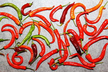 red and green chili peppers on a gray background