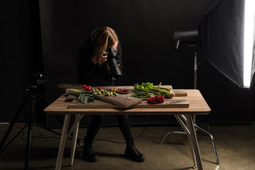 professional photographer making food composition for commercial photography and taking photo on...