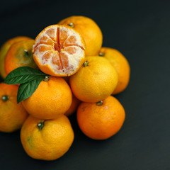 tangerines on a black background. healthy food concept, eco-friendly natural products, vegetarian, raw, organic, Tropical abstract background.