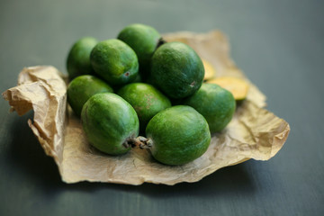 Feijoa green on black background. Feijoa Sellova is a fruit crop from tropical regions. Organic agricultural fruit, healthy food concept, eco-friendly natural products, vegetarian, raw harvest