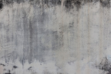 The background of the cement wall with black water stains