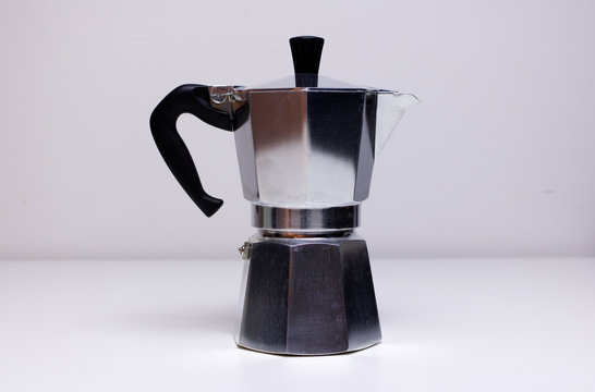 A Vintage Classic Aluminium Stovetop Espresso Coffee Maker On A Simple White Background