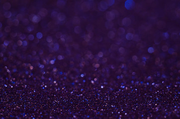 Abstract New Year purple bokeh background with shining defocus sparkles. Blurred glitters...