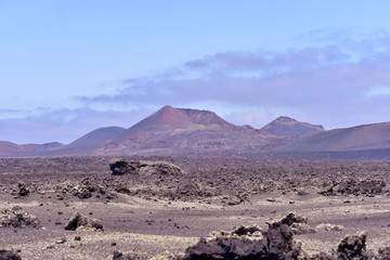 Fototapeta na wymiar Fire Mountains and volcanic lava stone in Timanfaya National Park, Lanzarote, Canary Islands, Spain