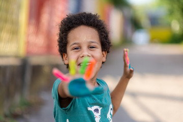 beautiful happy boy with painted hands