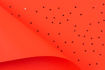 Red paper in geometric shape with glitter stars. Abstract Christmas, New year, festive background