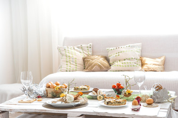 The interior of the room with a festive Easter table .