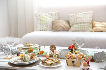 The interior of the room with a festive Easter table .
