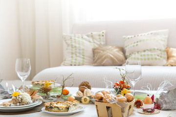 The interior of the room with a festive Easter table .