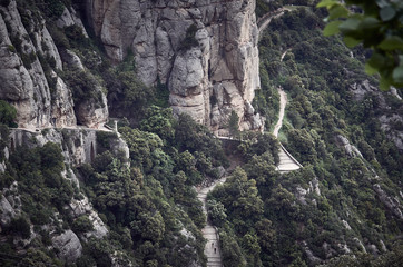 Path crossing between big rocks and forest