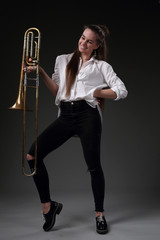 A life-size portrait of a girl with a trombone