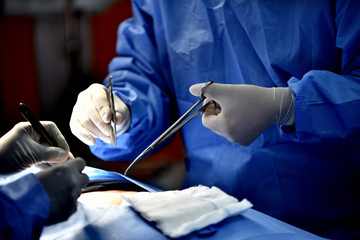 Medical Team Performing Surgical Operation in Modern Operating Room. Equipment and medical devices in hybrid operating room.scrub nurse preparing medical instruments for operation.