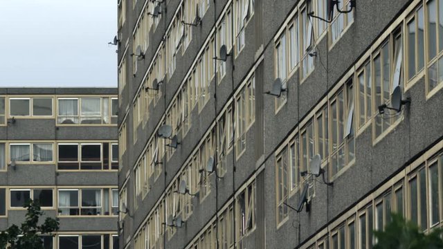 satellite dishes pepper side of apartment block