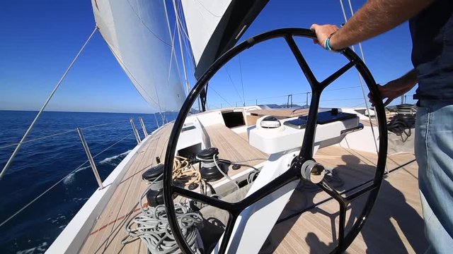 man driving sail boat