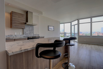 Vacant contemporary kitchen with open floorplan and city view