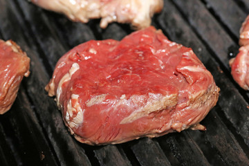Raw steak on the grill, close up