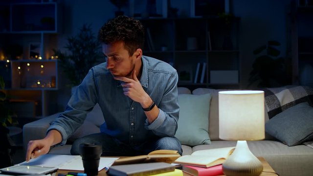 Young man freaks out due to failure while studying at home in the evening
