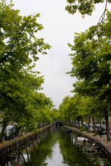 Fototapeta na wymiar View of canal, trees and bridge in Edam. It is a town famous for its semi hard cheese in the northwest Netherlands, in the province of North Holland.