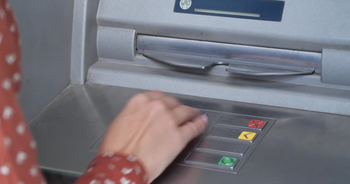 Woman using cash machine for money withdrawal outdoors, closeup