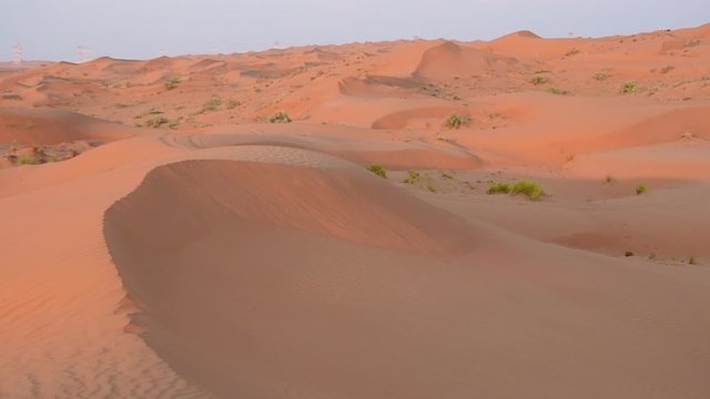 Panorama of the sand dunes looking at the ripples and textures of the sand in the evening sunset light in Ras al Khaimah, United Arab Emirates (UAE) near Dubai.