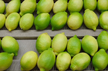 Fresh limes fruits on the shelf in the supermarket.