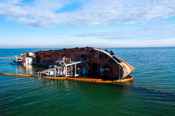 Fototapeta na wymiar damaged ship near the coast breakwater