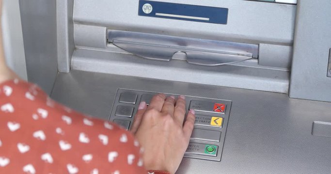 Woman using cash machine for money withdrawal outdoors, closeup