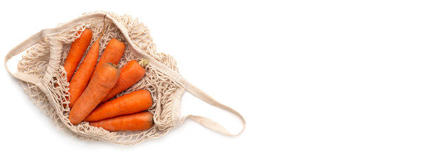 Organic carrots inside ecology clean net bag isolated on white