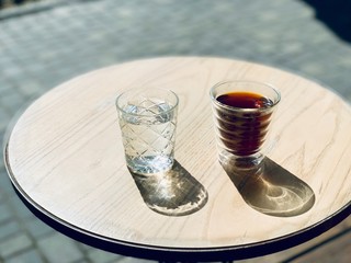 glass of coffee and water On wooden table