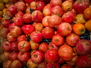 Naklejka na ściany i meble Delicious and fresh red pomegranate for healthy lifestyle and diet. Stacked in a shop for sale.