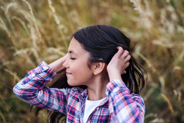 A school child standing on field trip in nature, headshot. Copy space.