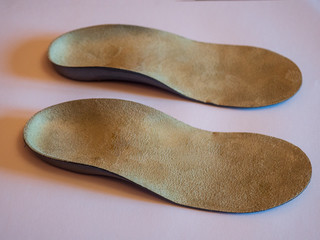 Medical orthopedic insoles for shoes on white background