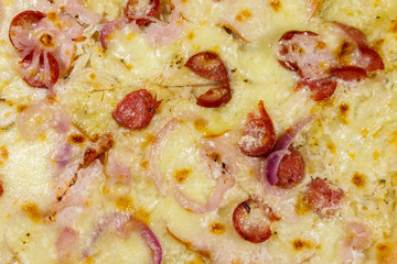 Texture of a delicious fresh pizza with sausage, red onion and cheese