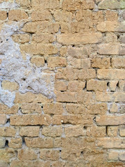 Very old and weathered traditional wall exterior with a rough texture brown facade made of stone rock bricks