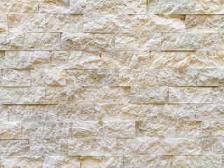 Interesting white bricks on a wall made of stone and rocks for outdoor decoration and cool wallpaper background