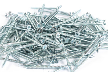 Galvanized metal screws.  45 mm screws.  Fixing materials on a white background.  A bunch of long...