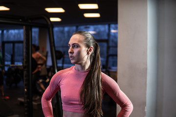 A girl with a barbell in fitness is engaged in sports, working out. Exercises. Bench press. Shakes her ass.