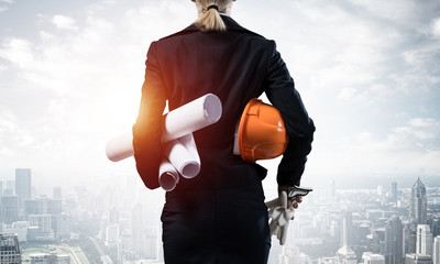 Architect standing with construction drawings