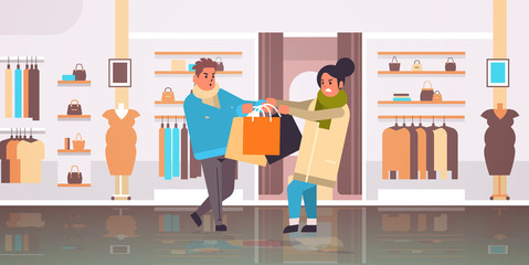 shoppers couple fighting for last gift box man woman customers pulling purchases in different directions sale fight seasonal shopping concept modern clothing boutique interior horizontal vector