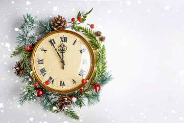 Twelve o'clock, like New Year's Eve. Gold vintage clock in a Christmas decor on a white background....