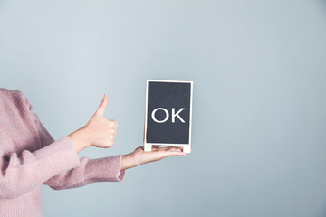 woman hand ok text on chalkboard