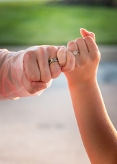 groom and bride twist pinky fingers symbolizing just married